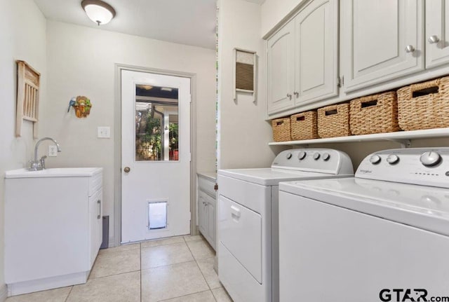 clothes washing area with light tile patterned flooring, cabinet space, a sink, and separate washer and dryer