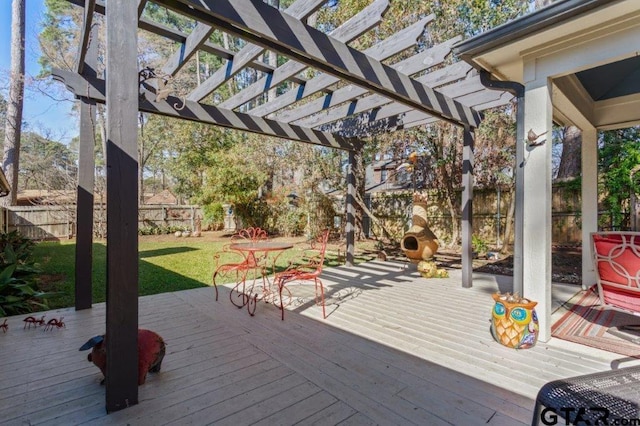 wooden terrace with a fenced backyard, outdoor dining area, a pergola, and a yard