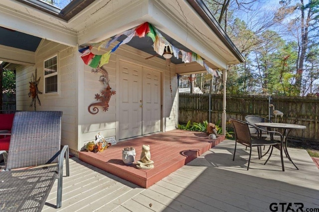 wooden deck featuring outdoor dining area and fence