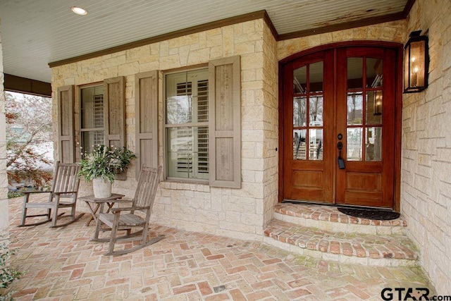 doorway to property featuring french doors and a porch