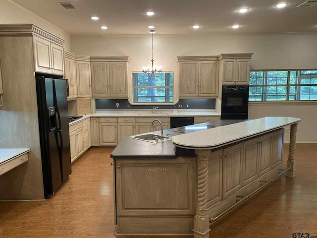 5304 Cedar Creek Dr, Kemp, TX 75143 - kitchen featuring black appliances, a center island with sink, light wood-type flooring, recessed lighting, and a chandelier