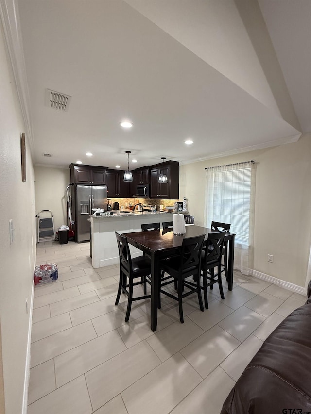 402 E Mims St, Tyler, TX 75702 - dining space with recessed lighting, crown molding, and light tile patterned floors