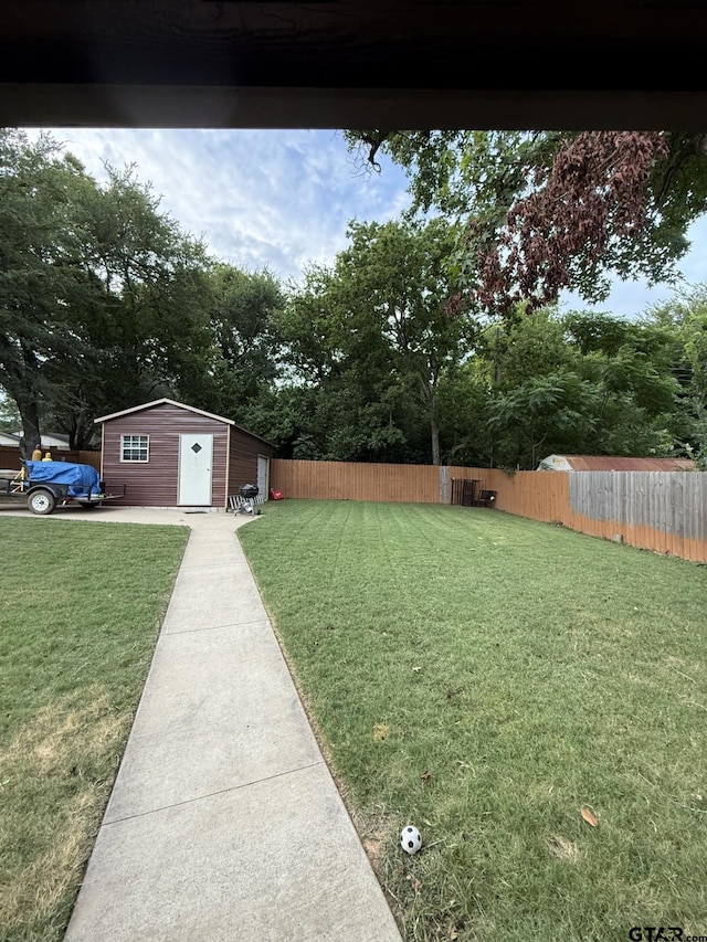 402 E Mims St, Tyler, TX 75702 - fenced backyard with view of scattered trees and a storage shed