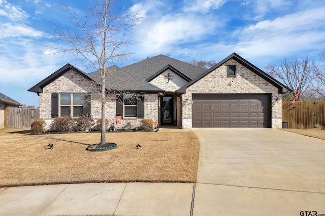 view of front of home featuring a garage and a front lawn