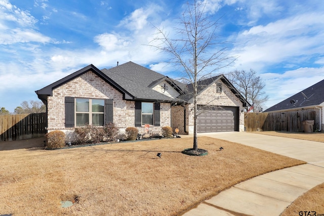 view of front of property with a garage and a front lawn