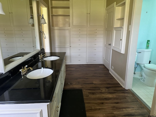1248 Canada St, Jacksonville, TX 75766 - full bathroom with wood finished floors, toilet, and double vanity