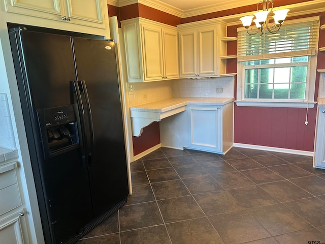 kitchen with tasteful backsplash, black fridge, crown molding, decorative light fixtures, and an inviting chandelier