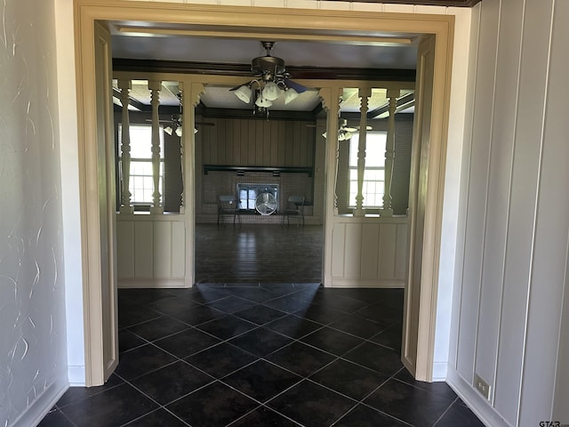 1248 Canada St, Jacksonville, TX 75766 - hallway featuring dark tile patterned floors, healthy amount of natural light, and baseboards
