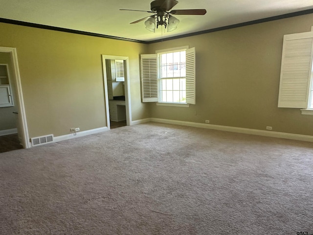 unfurnished bedroom with carpet floors and crown molding