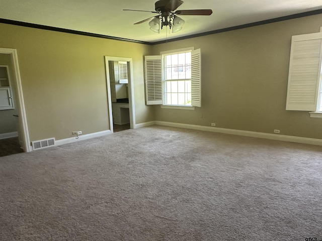 1248 Canada St, Jacksonville, TX 75766 - spare room with crown molding, a ceiling fan, baseboards, and carpet floors