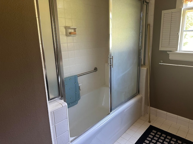 bathroom featuring tile patterned flooring and enclosed tub / shower combo