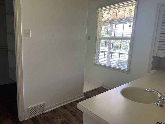 1248 Canada St, Jacksonville, TX 75766 - bathroom with wood finished floors, a sink, and baseboards