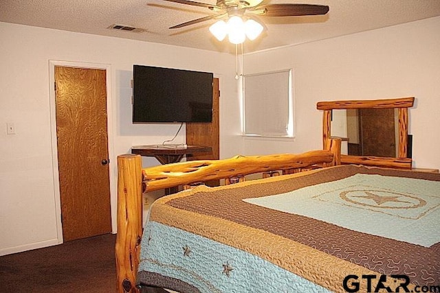 carpeted bedroom with a textured ceiling and ceiling fan