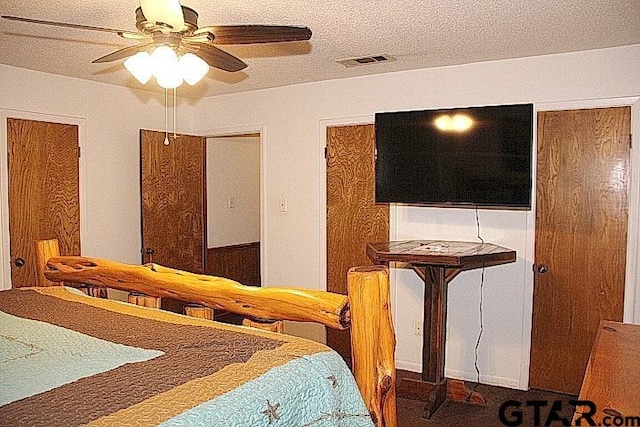 bedroom with a textured ceiling and ceiling fan