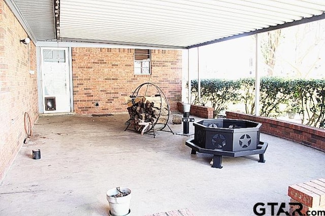 view of patio / terrace featuring an outdoor fire pit