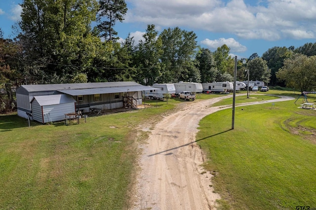 view of front of home with a front yard and a storage unit