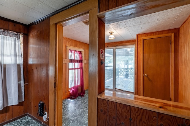 entryway featuring wooden walls