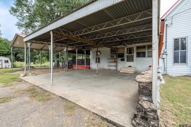 view of patio with a storage shed and a carport