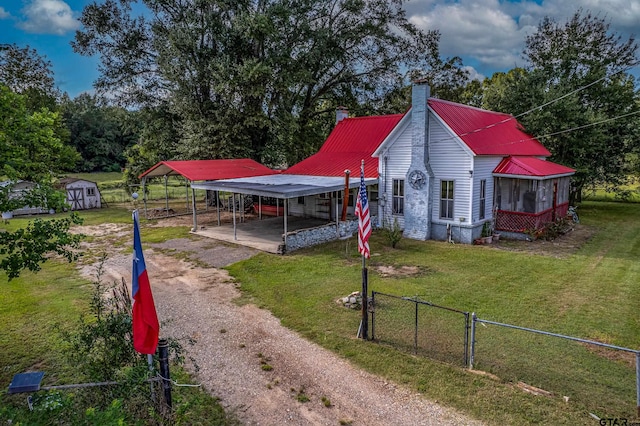 view of yard featuring a carport and a storage shed