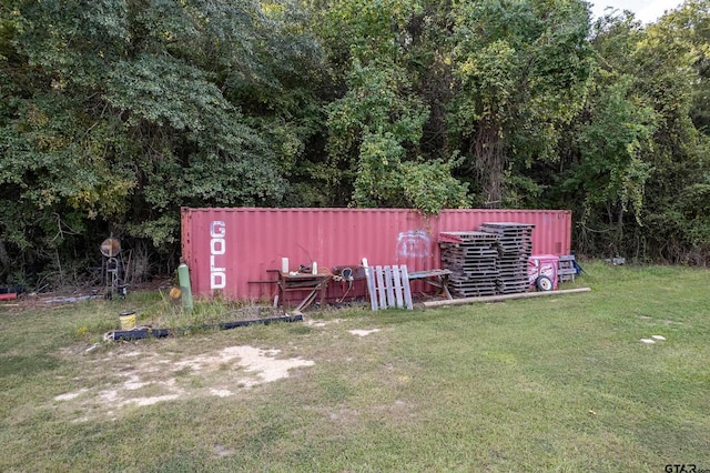 view of outbuilding featuring a lawn