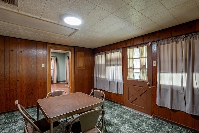 dining area with wooden walls