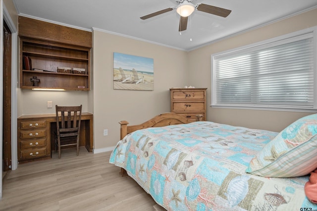 bedroom featuring light hardwood / wood-style flooring, ceiling fan, and crown molding