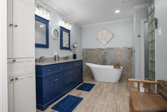 bathroom featuring wood-type flooring, crown molding, tile walls, and a tub