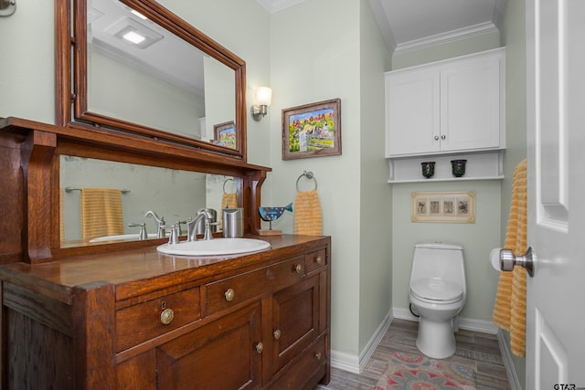 bathroom with hardwood / wood-style flooring, vanity, toilet, and crown molding
