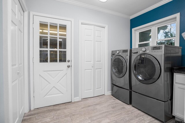 washroom with washer and dryer, light wood-type flooring, cabinets, and crown molding
