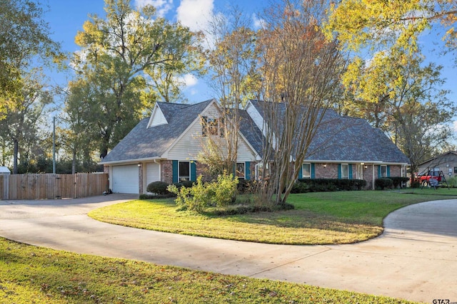 cape cod home featuring a front yard and a garage