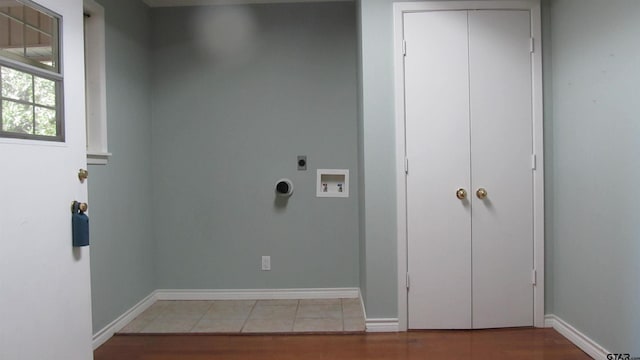 clothes washing area featuring washer hookup, electric dryer hookup, and hardwood / wood-style flooring