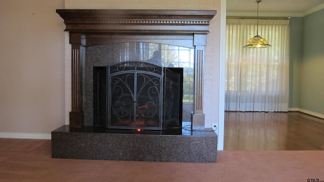 room details featuring a tile fireplace, hardwood / wood-style flooring, and crown molding