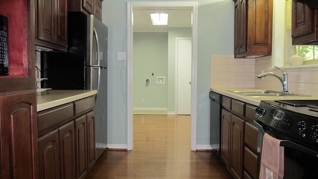 kitchen with black range with electric stovetop, sink, dark hardwood / wood-style flooring, stainless steel dishwasher, and backsplash