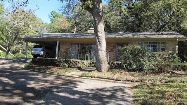 single story home featuring a carport