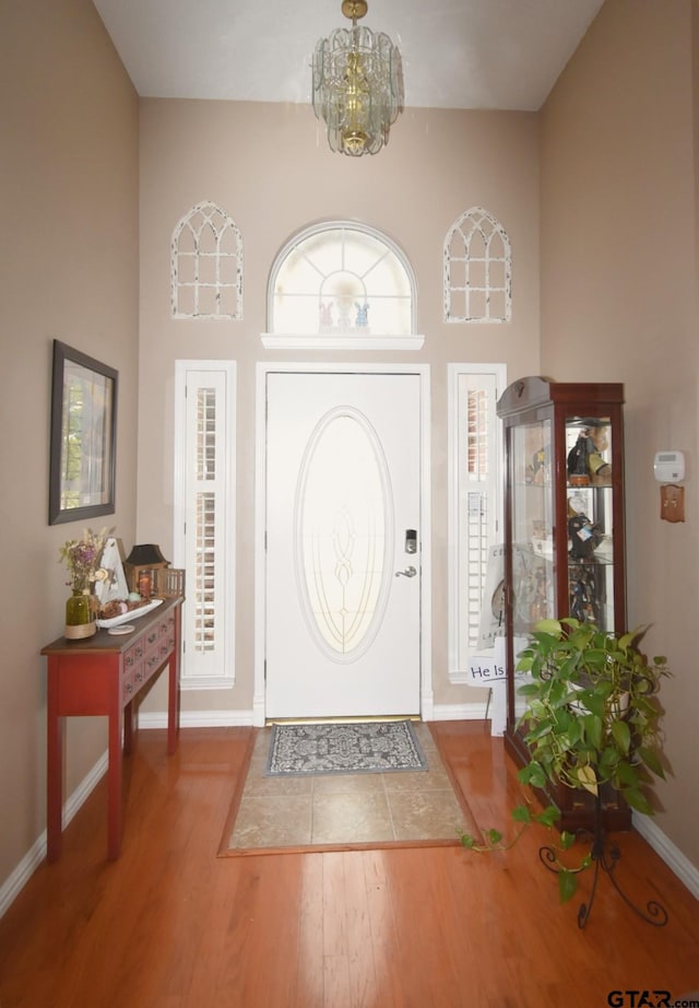 2333 Baretta Dr, Mesquite, TX 75181 - foyer with wood finished floors, a high ceiling, a chandelier, baseboards, and healthy amount of natural light