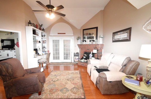 2333 Baretta Dr, Mesquite, TX 75181 - living room featuring a ceiling fan, light wood finished floors, vaulted ceiling, and a brick fireplace