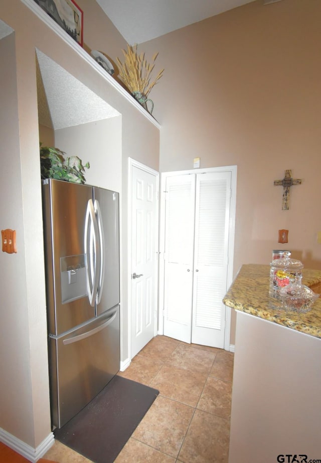 2333 Baretta Dr, Mesquite, TX 75181 - kitchen featuring stainless steel fridge with ice dispenser, light tile patterned floors, and baseboards