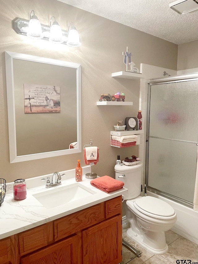 2333 Baretta Dr, Mesquite, TX 75181 - full bathroom featuring a textured ceiling, tile patterned floors, vanity, toilet, and enclosed tub / shower combo