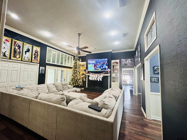 living room with dark hardwood / wood-style flooring, a wealth of natural light, crown molding, and ceiling fan