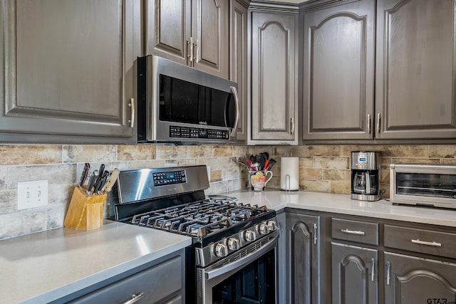 8533 Fm 315, Frankston, TX 75763 - kitchen featuring appliances with stainless steel finishes, gray cabinetry, backsplash, and light countertops