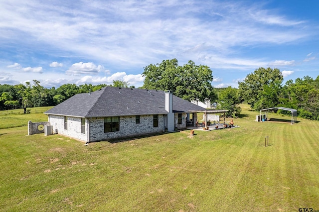 8533 Fm 315, Frankston, TX 75763 - back of property featuring a lawn, brick siding, a patio, a detached carport, and roof with shingles