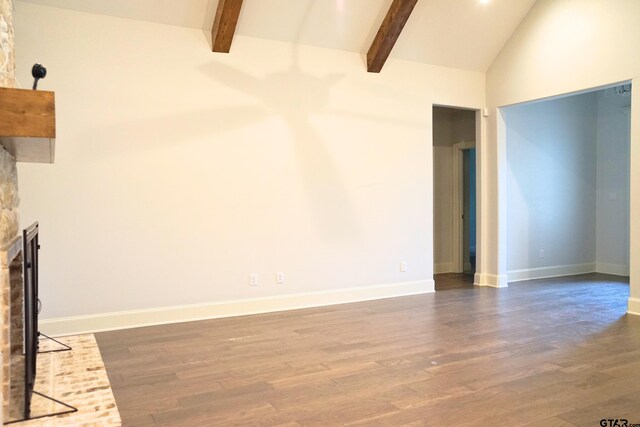unfurnished living room with baseboards, a fireplace, beam ceiling, and dark wood-style flooring