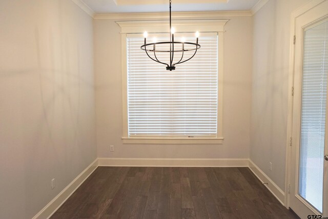 unfurnished dining area with baseboards, dark wood-style flooring, ornamental molding, and a notable chandelier