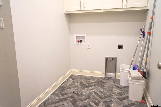 clothes washing area featuring washer hookup, baseboards, brick floor, hookup for an electric dryer, and cabinet space