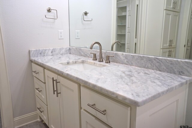 bathroom featuring vanity and baseboards