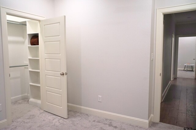 unfurnished bedroom featuring baseboards and carpet
