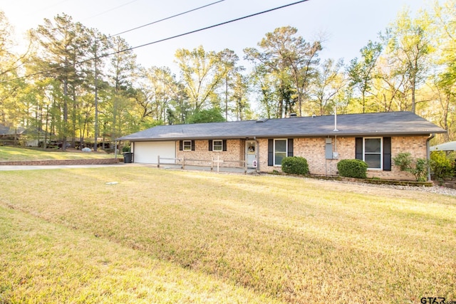 ranch-style house featuring a front lawn, an attached garage, and brick siding