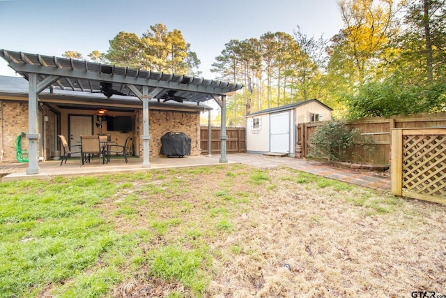 back of house with an outbuilding, a patio area, a shed, a pergola, and brick siding