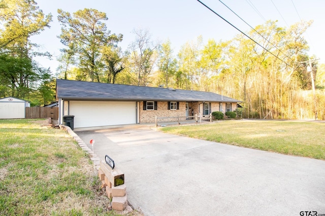 single story home with brick siding, fence, a garage, driveway, and a front lawn