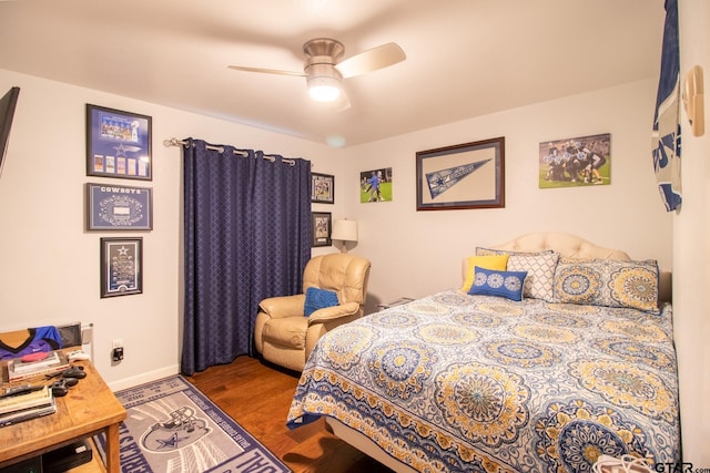 bedroom featuring ceiling fan, baseboards, and wood finished floors